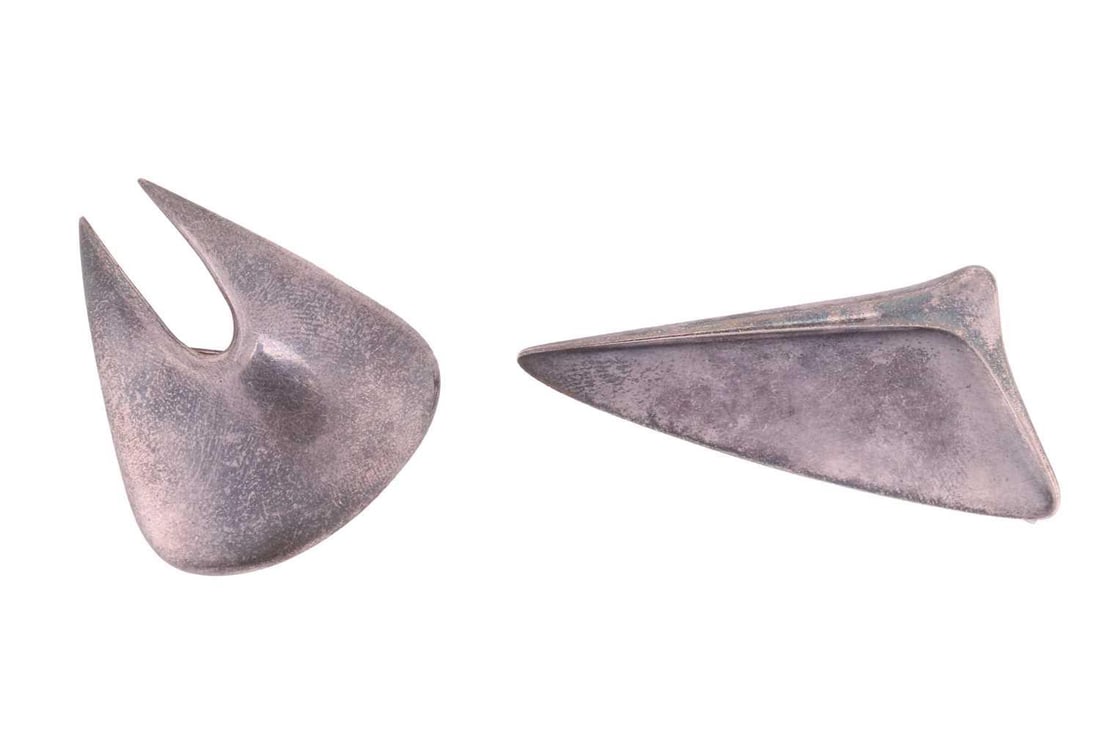 A Georg Jensen brooch and an abstract brooch; the Georg Jensen abstract brooch designed by Henning: A Georg Jensen brooch and an abstract brooch; the Georg Jensen abstract brooch designed by Henning Koppel, of plain polished abstract form, hinge pin and stamped 'Georg Jensen 327 Denmark' to reverse,