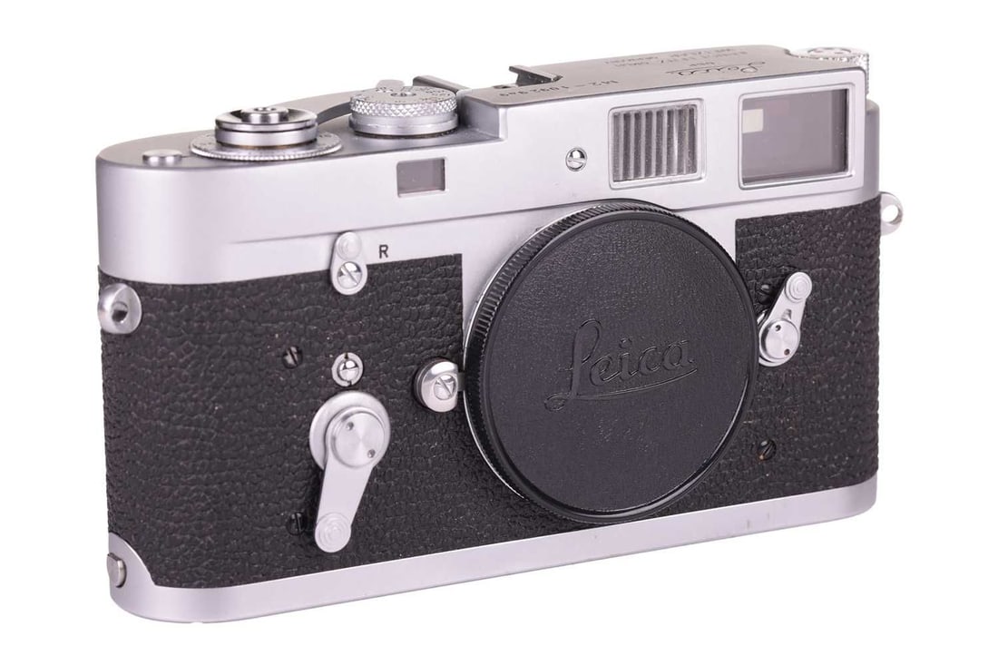 A Leica M2 Rangefinder Camera Body, 1964, chrome, serial number 1092949, with brown leather Leica: A Leica M2 Rangefinder Camera Body, 1964, chrome, serial number 1092949, with brown leather Leica carry case, together with an original Leica M1 / M2 Instruction Book. From a private collection, Hertf