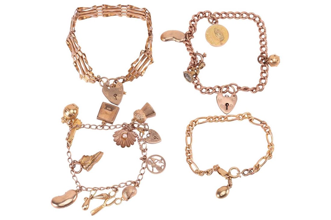 Four charm bracelets; comprising heart padlock charms, 9ct kidney bean charms and other, to 9ct and: Four charm bracelets; comprising heart padlock charms, 9ct kidney bean charms and other, to 9ct and yellow metal chains of figaro, curb and gate-link design; Gross weight 49.2 grams. (4)