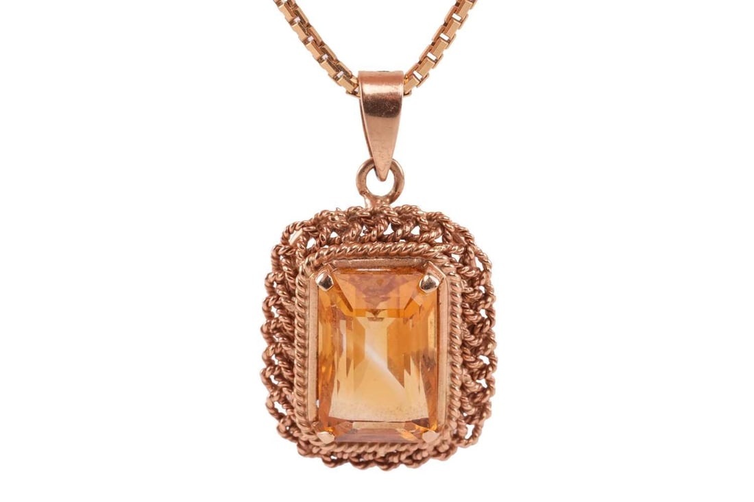 A citrine pendant on chain, featuring a rectangular stepcut citrine with canted corners, 12.2 x 8.0: A citrine pendant on chain, featuring a rectangular stepcut citrine with canted corners, 12.2 x 8.0 x 7.8 mm, set within a braided twisted rope surround with tapered bail, yellow metal marked "585", 2