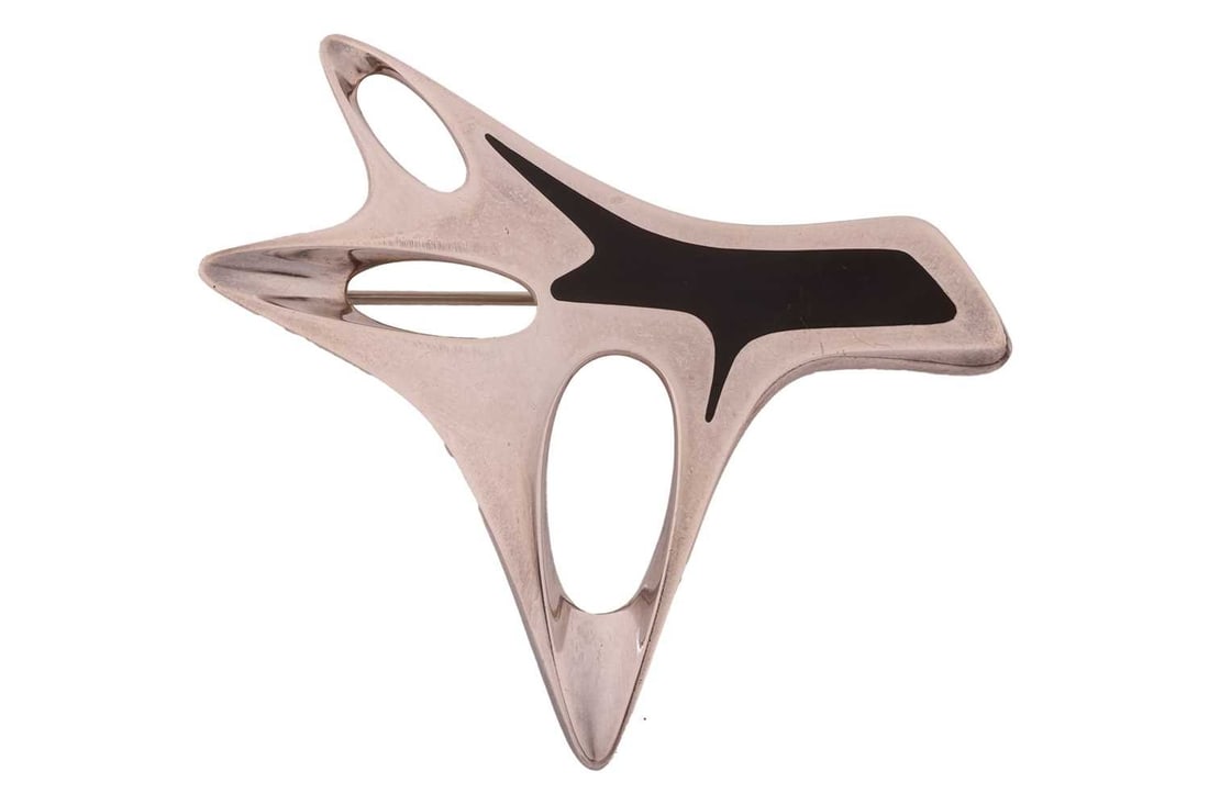 Georg Jensen a silver enamel brooch, with black enamel on an abstract panel, fitted with hinged pin: Georg Jensen a silver enamel brooch, with black enamel on an abstract panel, fitted with hinged pin stem and rollover safety catch, designed by Henning Koppel, No. 323, post1945 maker"s mark, London 2