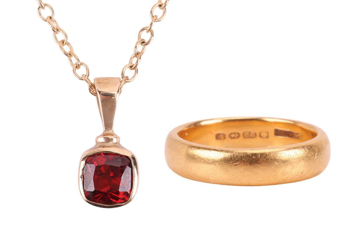 A garnet pendant on chain, and a 22ct gold wedding band; the pendant collet-set with a cushion-shape: A garnet pendant on chain, and a 22ct gold wedding band; the pendant collet-set with a cushion-shaped garnet in 9ct gold mount, on a 40.0 cm long cable link chain in 9ct gold; together with a wedding