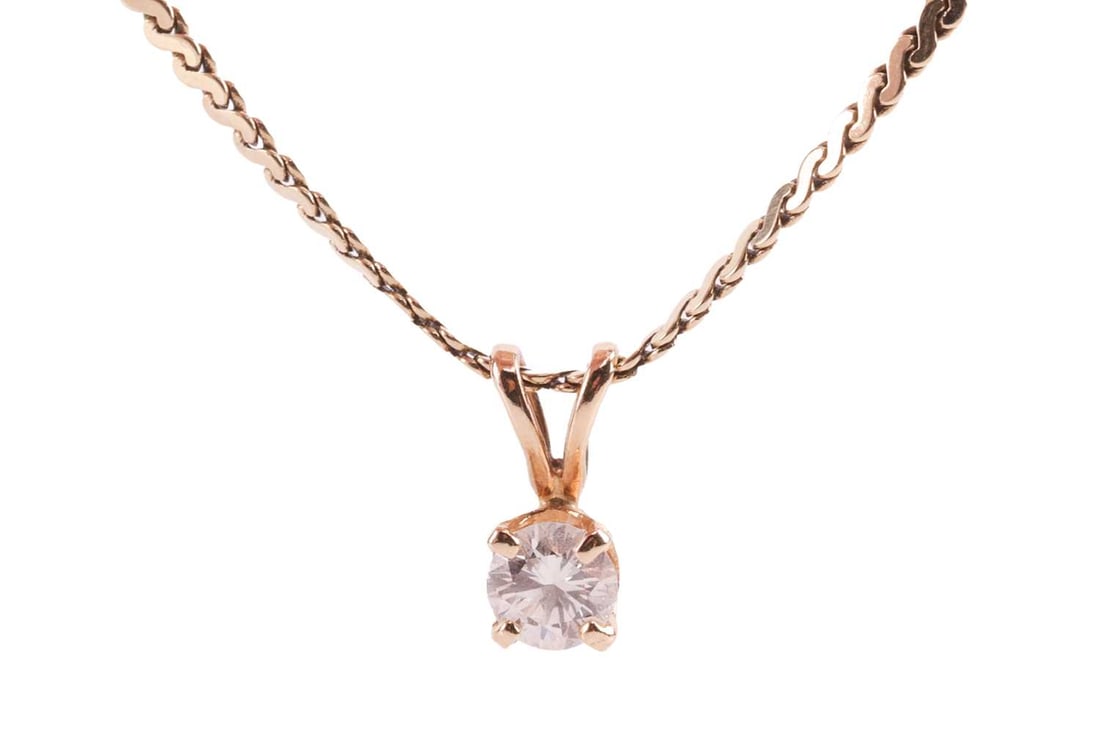 A diamond solitaire pendant on chain, featuring a central round brilliant diamond with an estimated: A diamond solitaire pendant on chain, featuring a central round brilliant diamond with an estimated weight of 0.22ct, to a serpentine-link chain with bolt ring catch marked '585', the necklace measuri