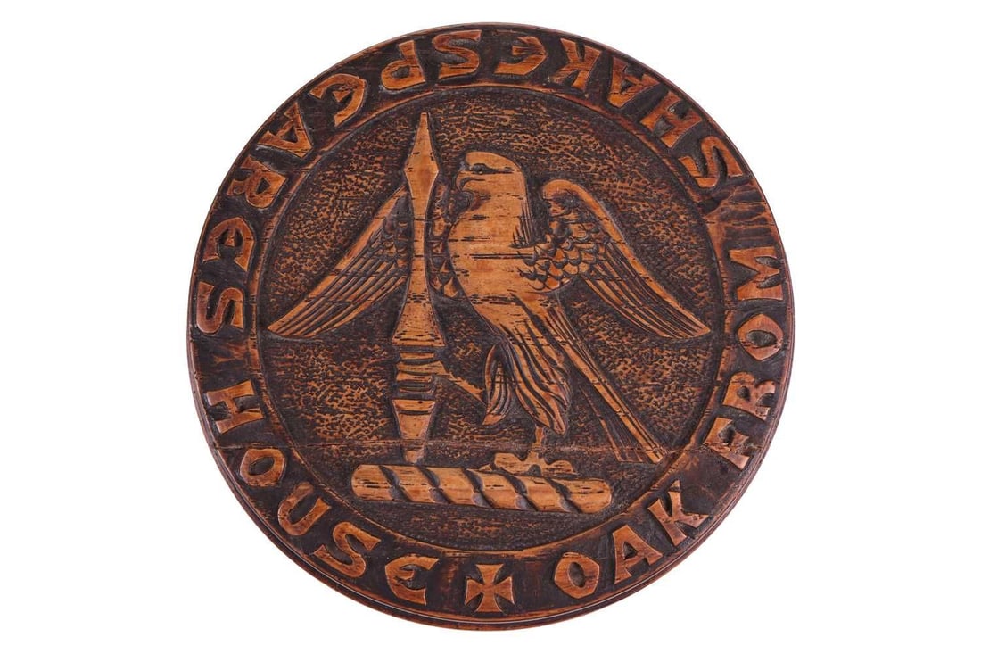 A 19th-century carved oak cylindrical box, titled 'Oak From Shakespeare's House' by John Marshall, 9: A 19th-century carved oak cylindrical box, titled 'Oak From Shakespeare's House' by John Marshall, 9 cm diameter x 2 cm high, the cover with a relief decorated crest, the interior with an affixed hand