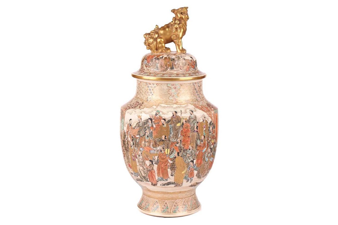A Japanese Satsuma pottery baluster vase and cover, Meiji period, late 19th century, the cover with: A Japanese Satsuma pottery baluster vase and cover, Meiji period, late 19th century, the cover with bold seated gilt lion dog finial painted with "a thousand faces" depicting numerous similar scholars