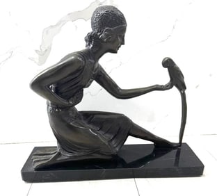 A patinated bronze sculpture depicting a dancing ballerina figure. With engraved signature