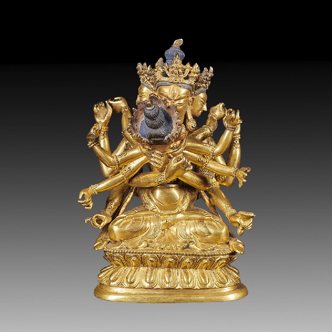 A GILT BRONZE MULTI ARMS AND FACE BUDDHA (1 of 5)