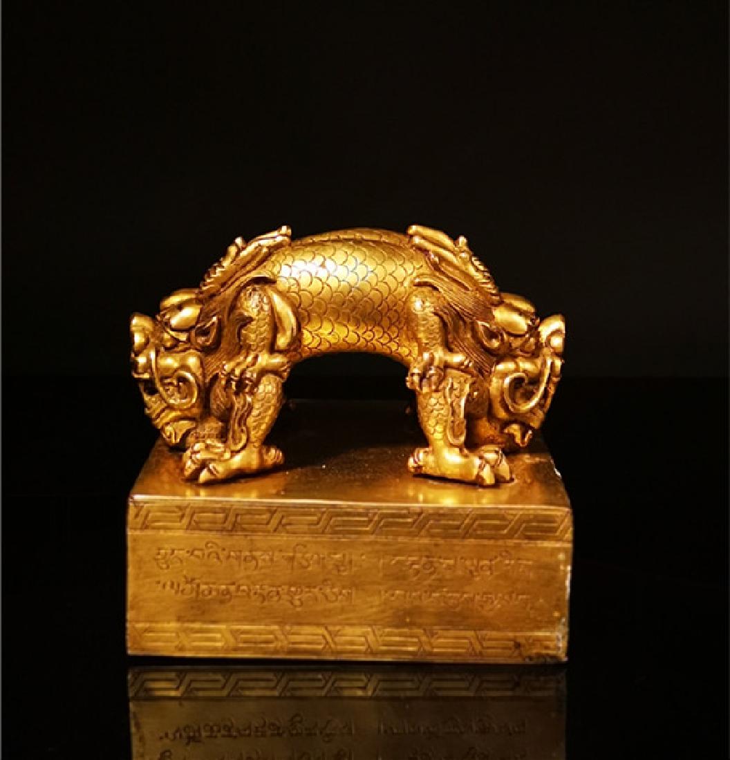 A GILT BRONZE MOLDED TIBETAN BUDDHIST SEAL (1 of 9)