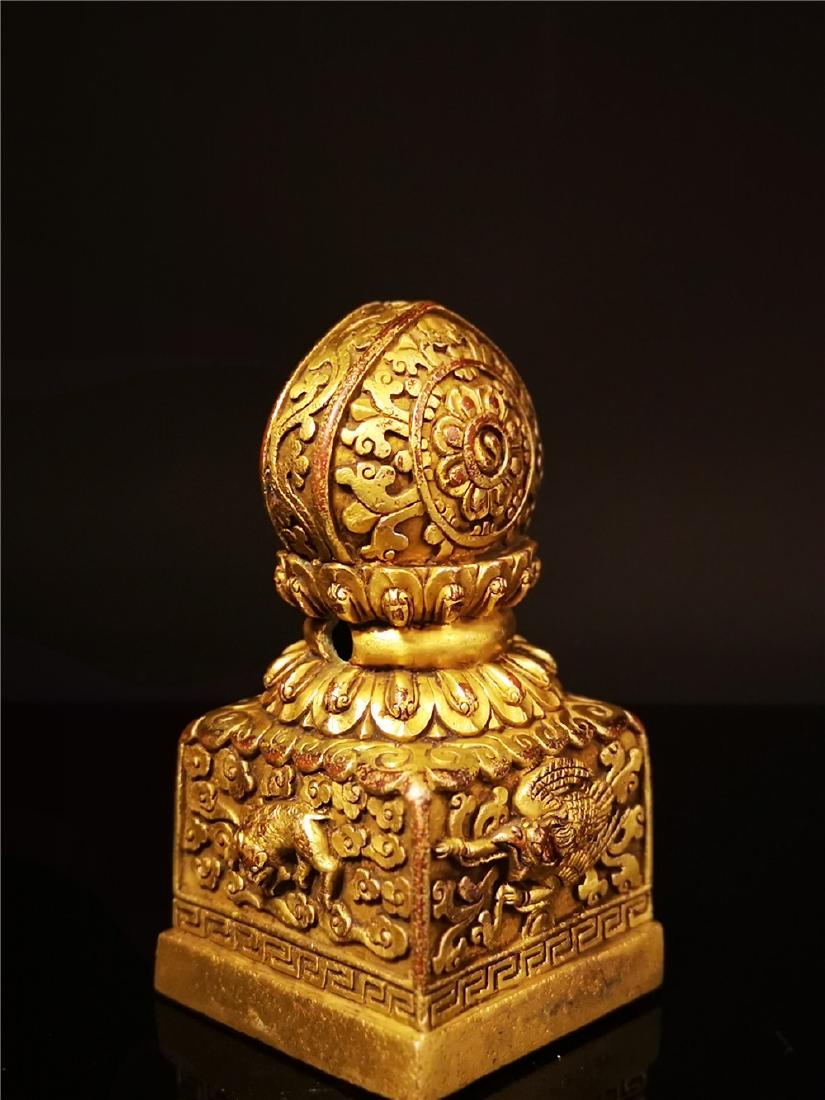 A GILT BRONZE MOLDED TIBETAN BUDDHIST SEAL (1 of 11)