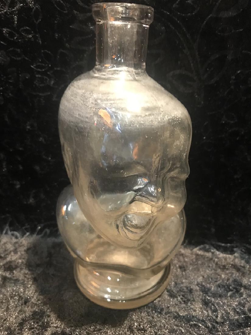 Crying Baby Figural Bottle: A "Crying Baby" figural bottle. Good condition. For dimensions, see photographs.