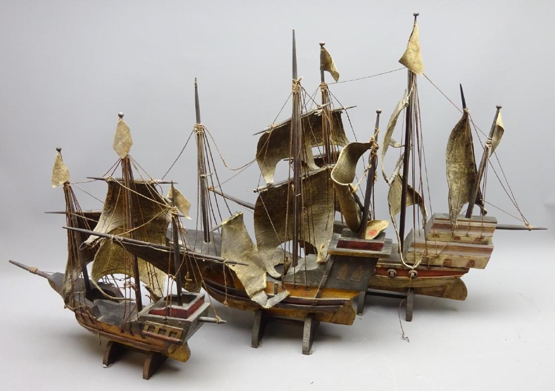 Three wooden models of three masted galleons, fully: Three wooden models of three masted galleons, fully rigged with solid hulls, canvas sails and painted detail, on stands, L70cm, H58cm, max (3)