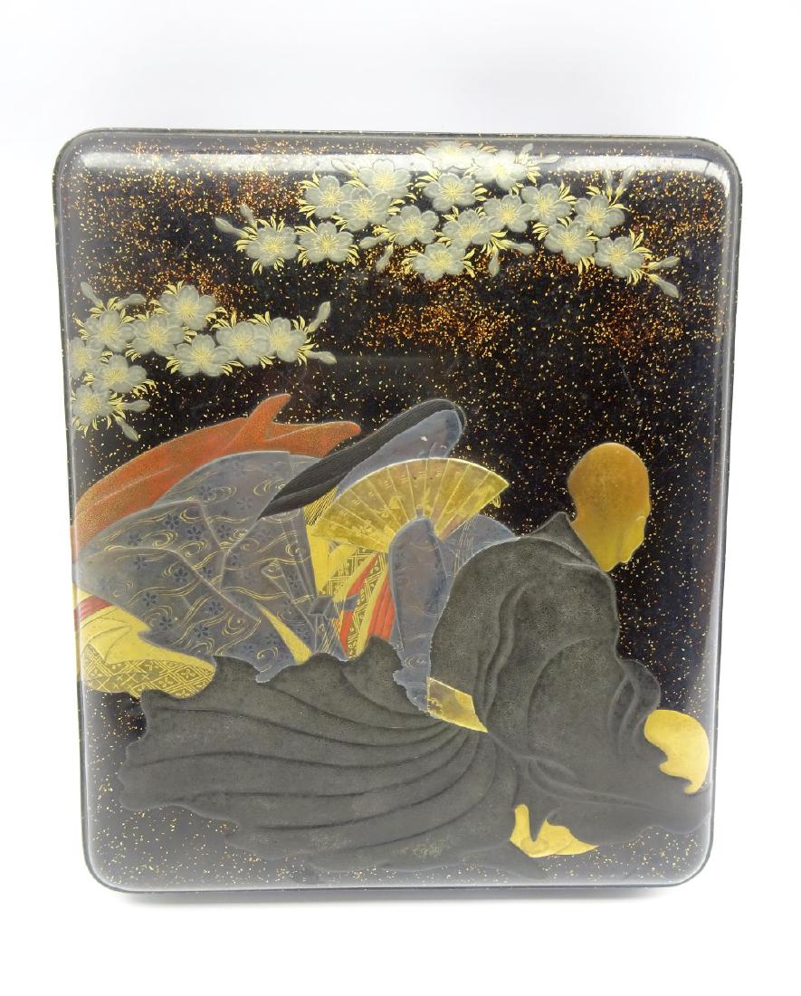 Japanese Lacquer Writing Box, Edo period, with a court: Japanese Lacquer Writing Box, Edo period, with a court lady and a monk beneath cherry blossom in gold, silver, red and black on a black ground with scattered nashiji, the interior of the cover with fa
