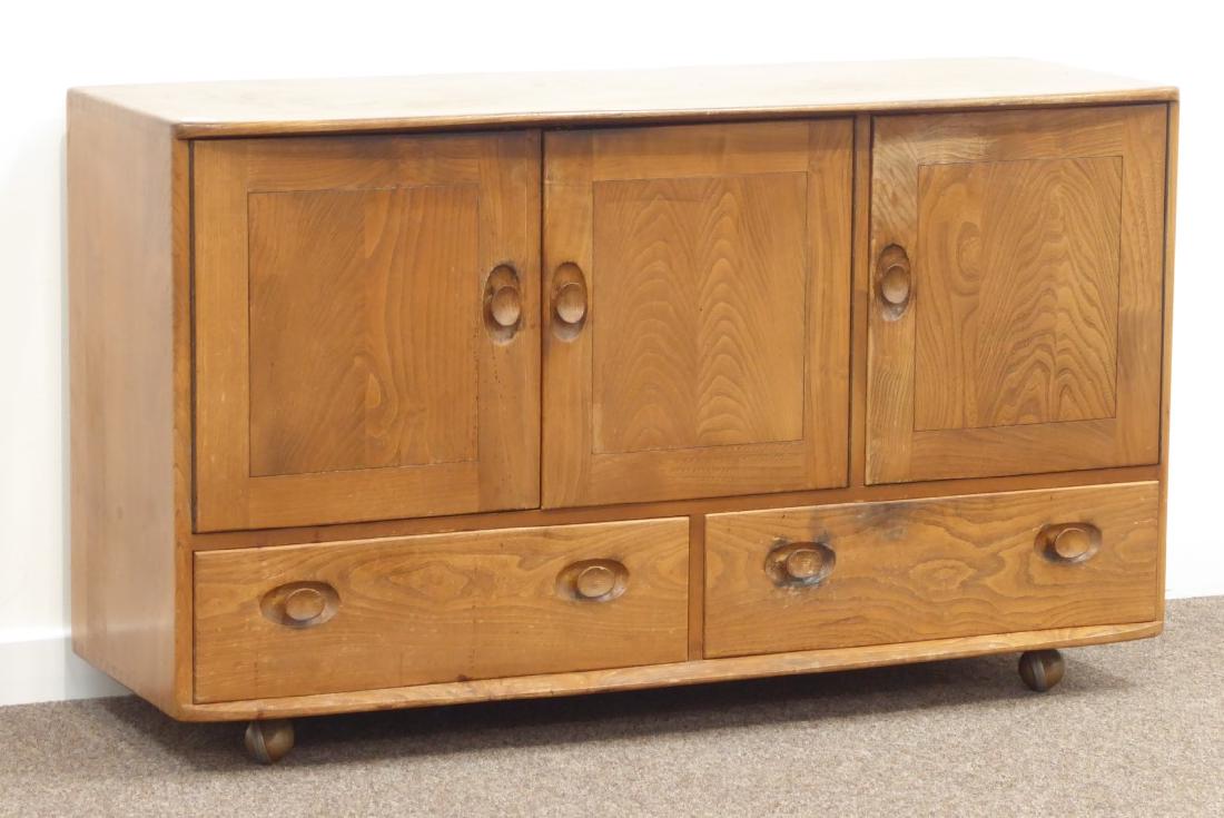 Ercol elm sideboard, three cupboards and two drawers,: Ercol elm sideboard, three cupboards and two drawers, W130cm, H76cm, D49cm