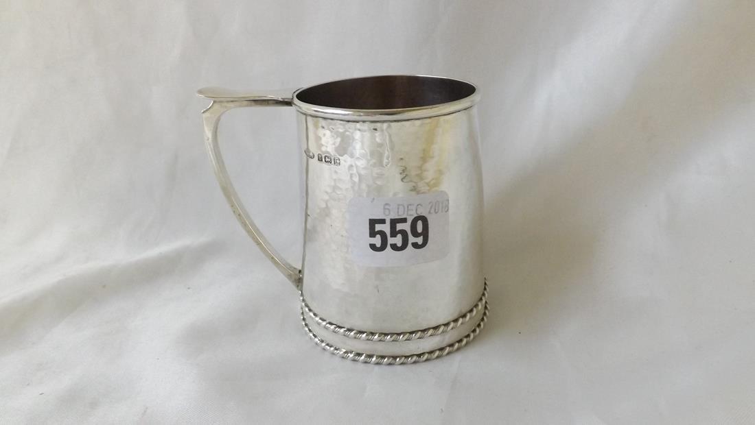 A.E. Jones childs christening mug with 2 rope twist: A.E. Jones childs christening mug with 2 rope twist bands to churn shaped body 3.5" over handle B'ham 1927 110g.