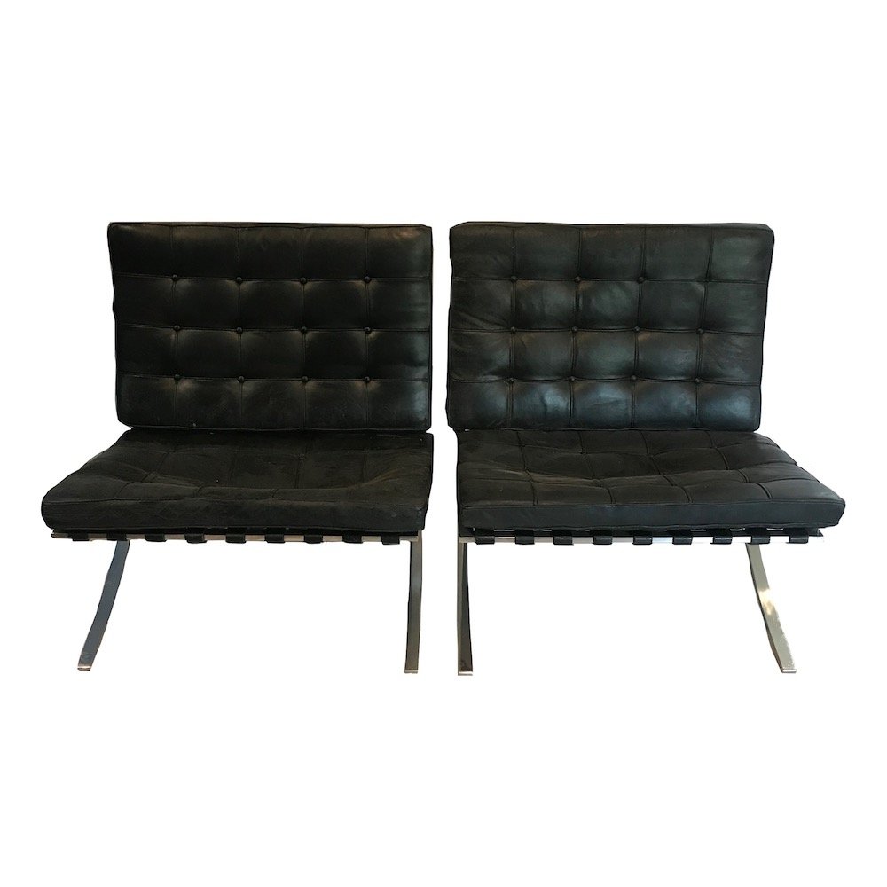 Mid-Century Knoll Pair of Mies Chairs: A beautiful pair of Barcelona chairs, designed by Mies van der Rohe in 1929, manufactured by Knoll International in the USA around 1970. These beautiful chairs are upholstered in black leather, giving