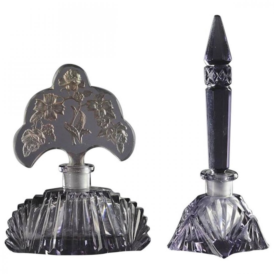 Two 1920s Czech Amethyst Glass Perfume Bottles: One with roses on stopper and Irice label on bottom. The other marked 'Made in Czechoslovakia' on the base. Both with wands. Dimensions are: largest 5.75" tall by 2" wide by 2" deep; other is 4.5" tal