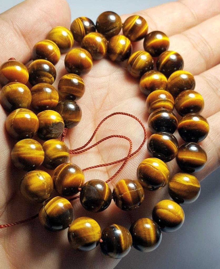 HAND CARVED BEADED TIGER EYE NECKLACE: SUPREME QUALITY HAND CARVED CALIBRATED BEADED TIGER EYE NECKLACE: Flat-rate of $23.00 to anywhere. shipping rates are determined by Parcel weight and destination. Combined shipping: 15$ for each addit