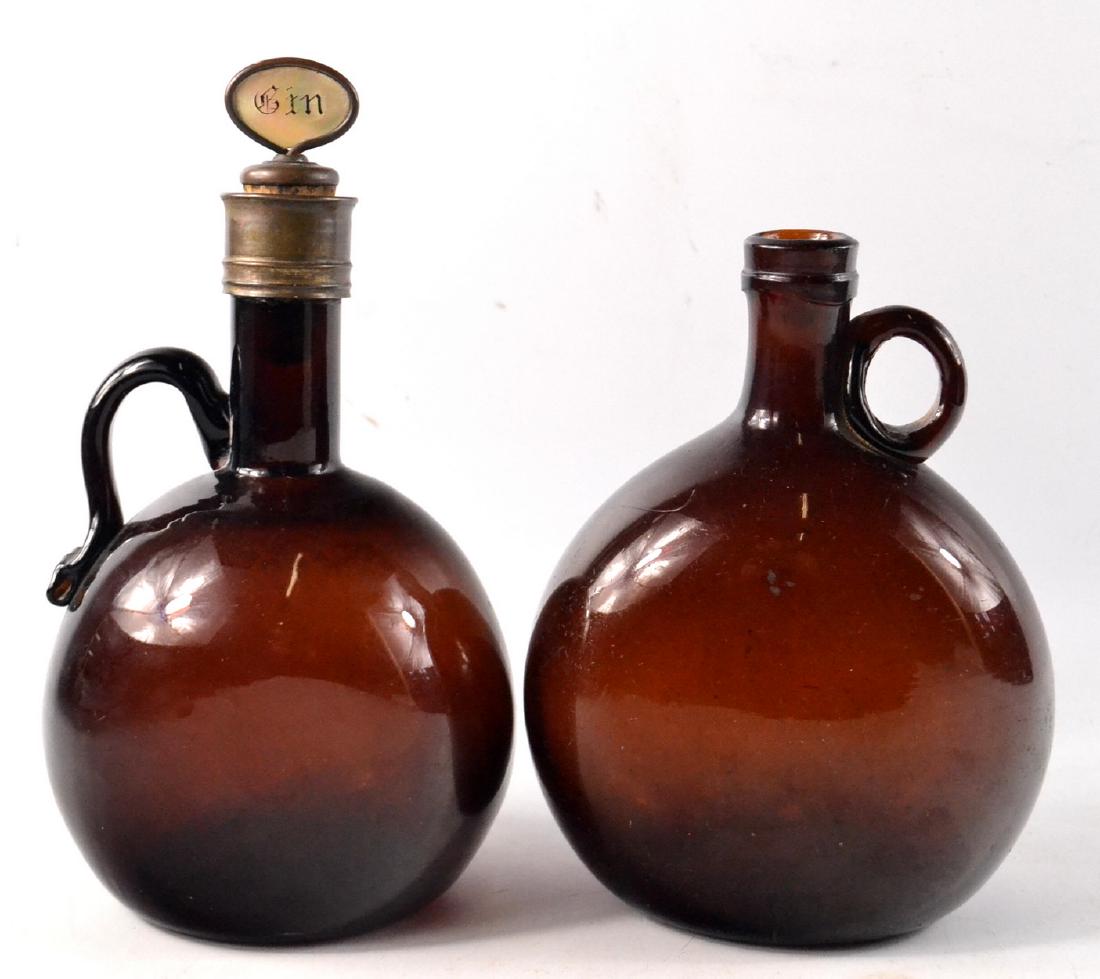 Two 19th century brown glass flasks, one with mother of: Two 19th century brown glass flasks, one with mother of pearl gin stopper W: 14cm and 12cm approx Gross weight approx 1.2kg
