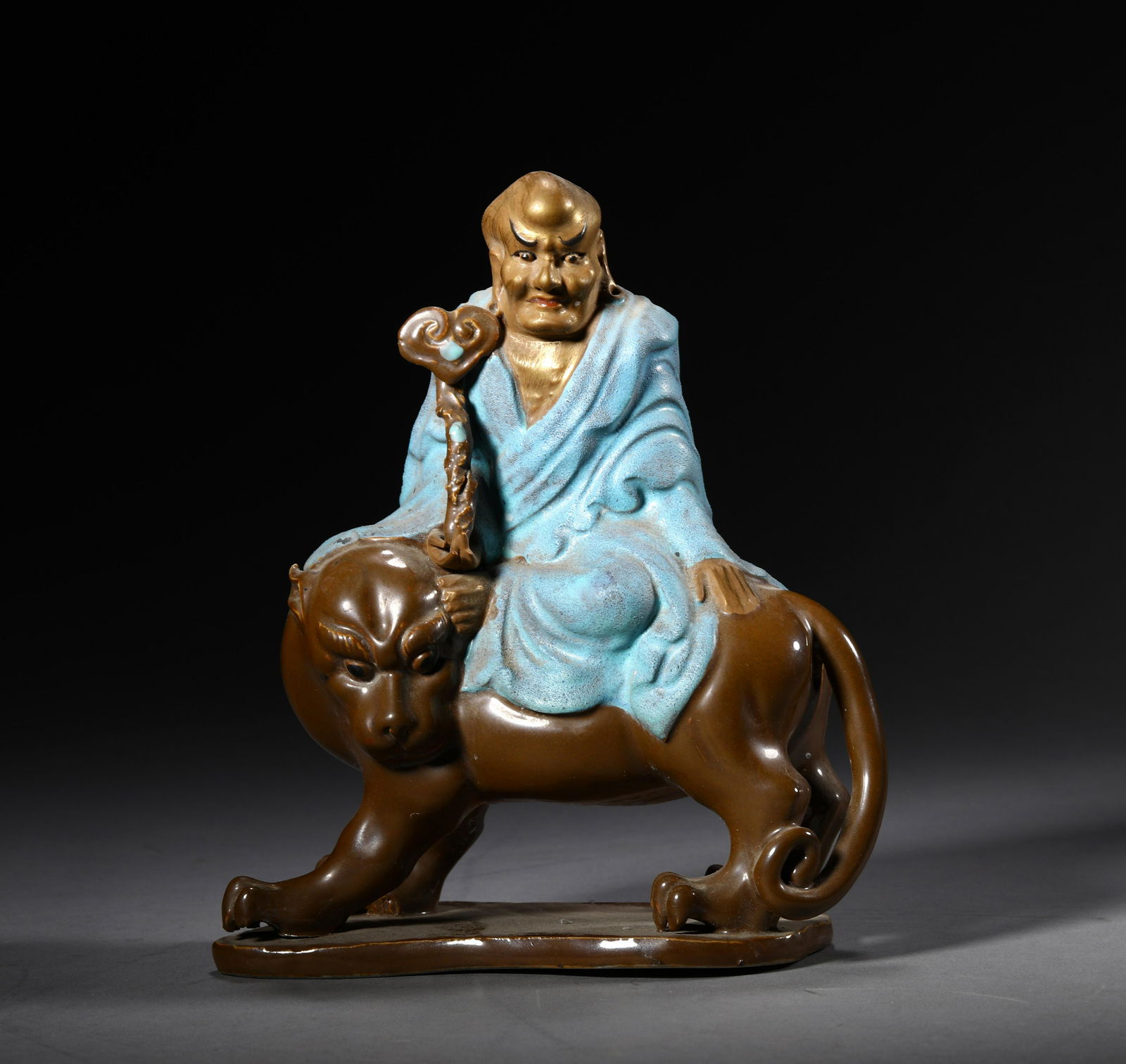 A LU JUN YOU GLAZED PORCELAIN LOHAN STATUE: A LU JUN YOU GLAZED PORCELAIN LOHAN STATUE. H: 15.5cm W: 13cm