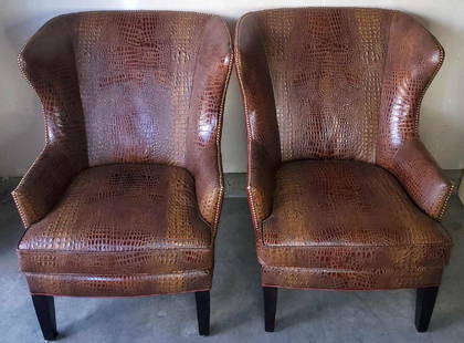 Two leather gator embossed tall backed lounge chairs: Both in excellent condition with only minor scuffs to the wood legs. Each decorated with brown Thomasville Outback pattern Caiman color button accented leather. Estimated replacement value $1250+ each