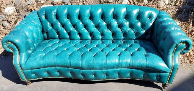 Hancock & Moore leather tavern sofa: The gorgeous American made sofa with Tiburon peacock turquoise leather, adorned with buttons and resting upon wooden legs with casters. In very good lightly used estate condition. Measures 82" x 36" x