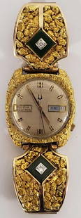 Bulova Accutton gold nugget, jade & diamond wristwatch: The large men's watch with face adorned with gold nuggets, flanked by two large 10k gold cuffs with inlaid jade and approximately 3mm brilliant round cut diamonds, all mounted to gold tone speidel ban