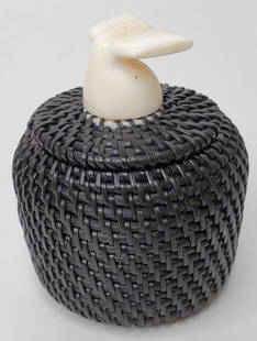 Carl Hank baleen basket with whale fluke finial: In excellent condition with no noted damage, the lid fitting tightly, signed on base. Measures 3" tall, 2.5" in diameter.