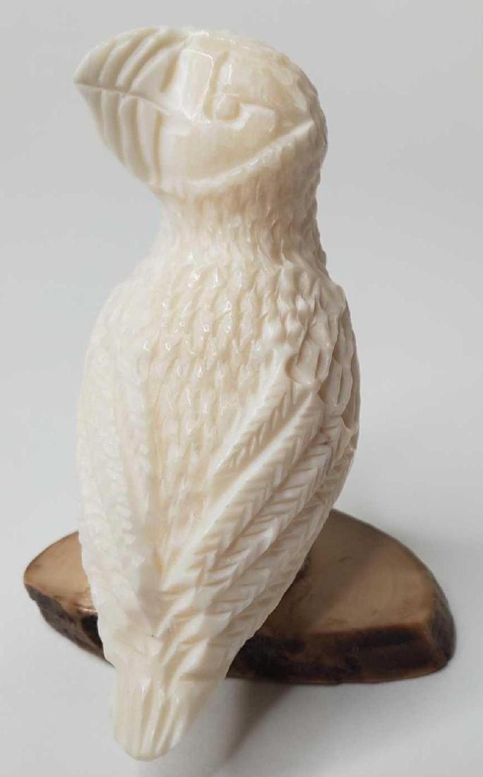 Carved Eskimo puffin signed Pelowook on fossilized base (1 of 5)