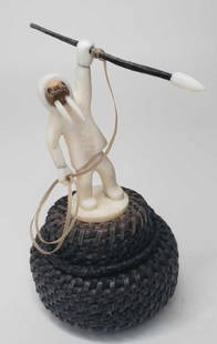 Baleen basket with elaborate spear hunter finial: The basket in very good condition with tall walrus effigy style hunter finial, signed on base by artist Jason Rentenan. 2.5" in diameter, 4.5" tall including finial.