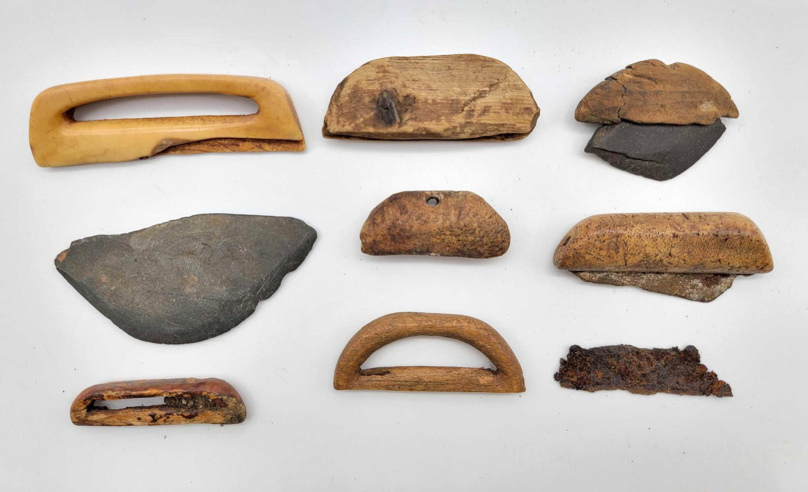 Children's Ulu Handles & Blades: A grouping of diminutive ulu & blade Eskimo artifacts, likely intended for children. Two of the eight objects in total are complete with affixed blades. Materials include walrus tusk, bone, wood, 