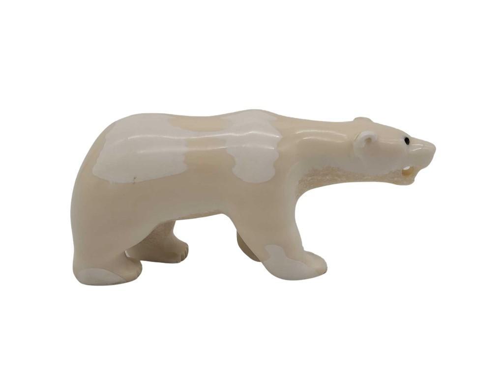 4.75" Carved Tusk Polar Bear: An Eskimo walrus tusk carving in the form of a polar bear, the tusk exhibits a pleasing variation of cream and white colors. Measures approximately 4.75" long x 1.75" x 2".