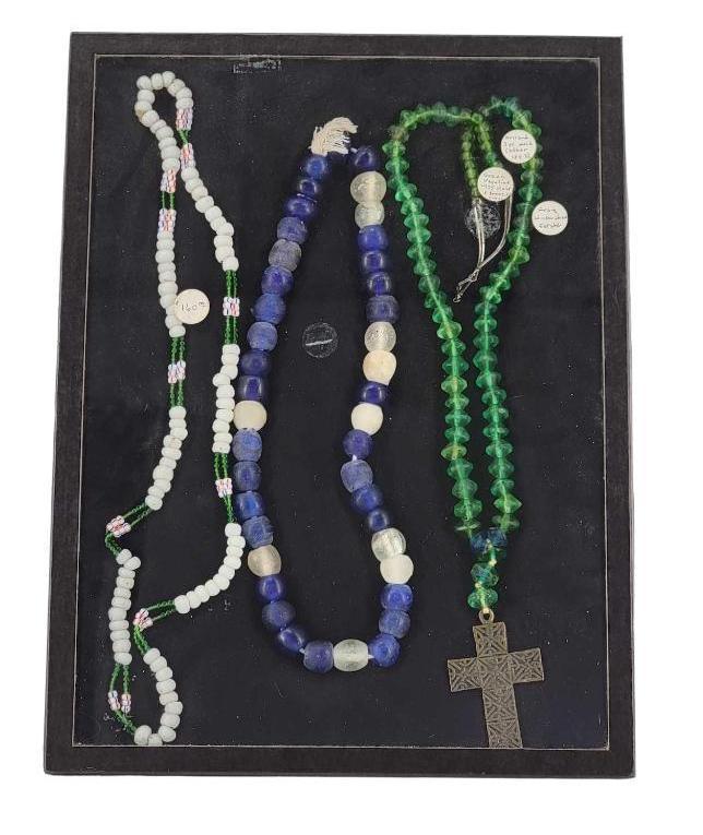 Cased Set of Trade Beads, One with Bronze Cross: Includes a green Vaseline beaded necklace with sterling silver clasp and bronze cross from the Judge James Wickersham Estate, and two blue/white glass trade bead necklaces. The largest necklace measur