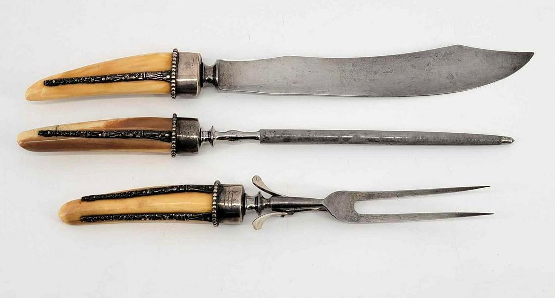 19th Century NWC Fossil Walrus Tusk & Totemic Silver Design Carving Set: A highly unusual late 19th or early 20th century three-piece carving set, the handles made of fossilized walrus tusk and silver cast in the shape of totem poles. The largest piece measures approximate