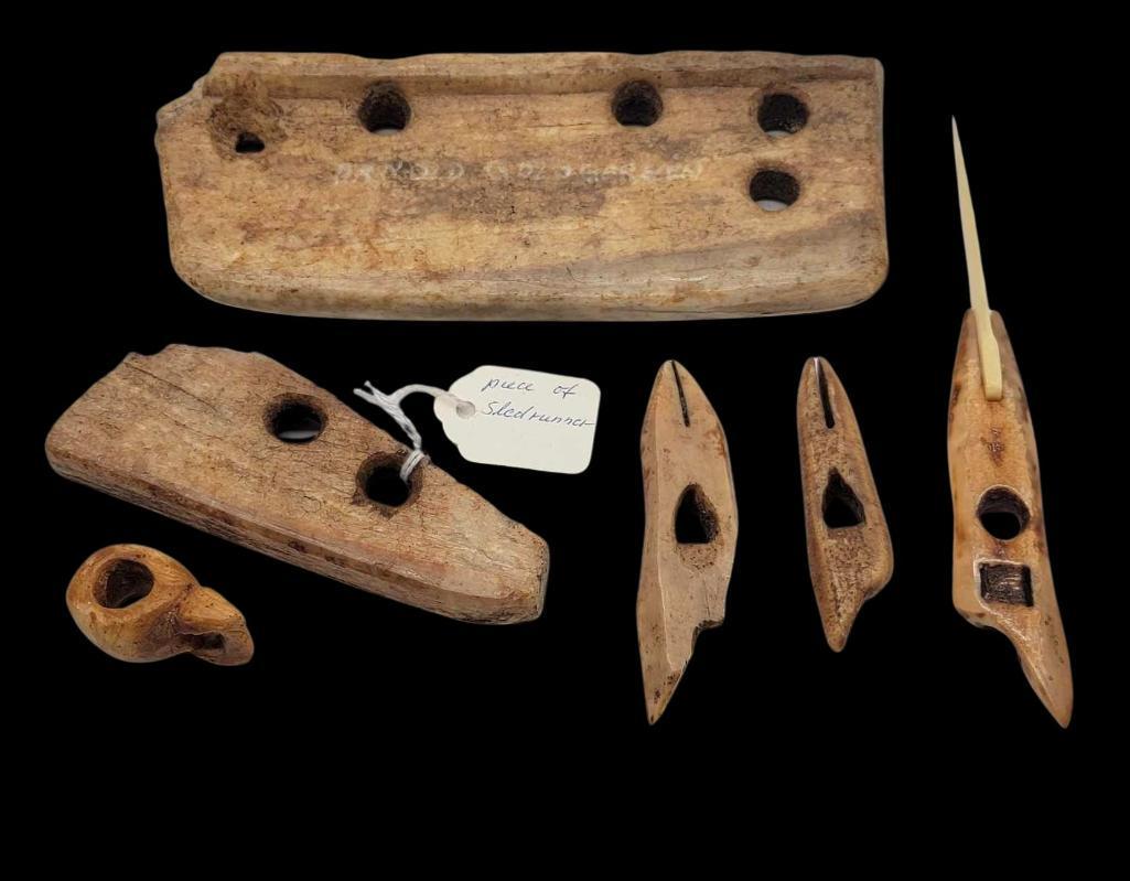 Group of Ancient Eskimo Fossilized Tusk Artifacts: A group of six Eskimo fossilized walrus tusk artifacts to include a toggle, two sled runner sections, and three harpoon heads, one of them with a later added fossilized tusk blade. The largest measure