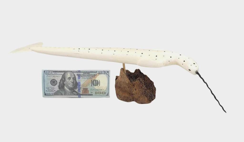 16" Eskimo Walrus Tusk & Baleen Narwhal by Charles Edwa: An extremely unusual and large walrus tusk carving of a narwhal with inlaid baleen features and baleen horn, mounted to a fossilized bone base. Signed "C.E" for the Savoonga, AK carver, Charles Edward
