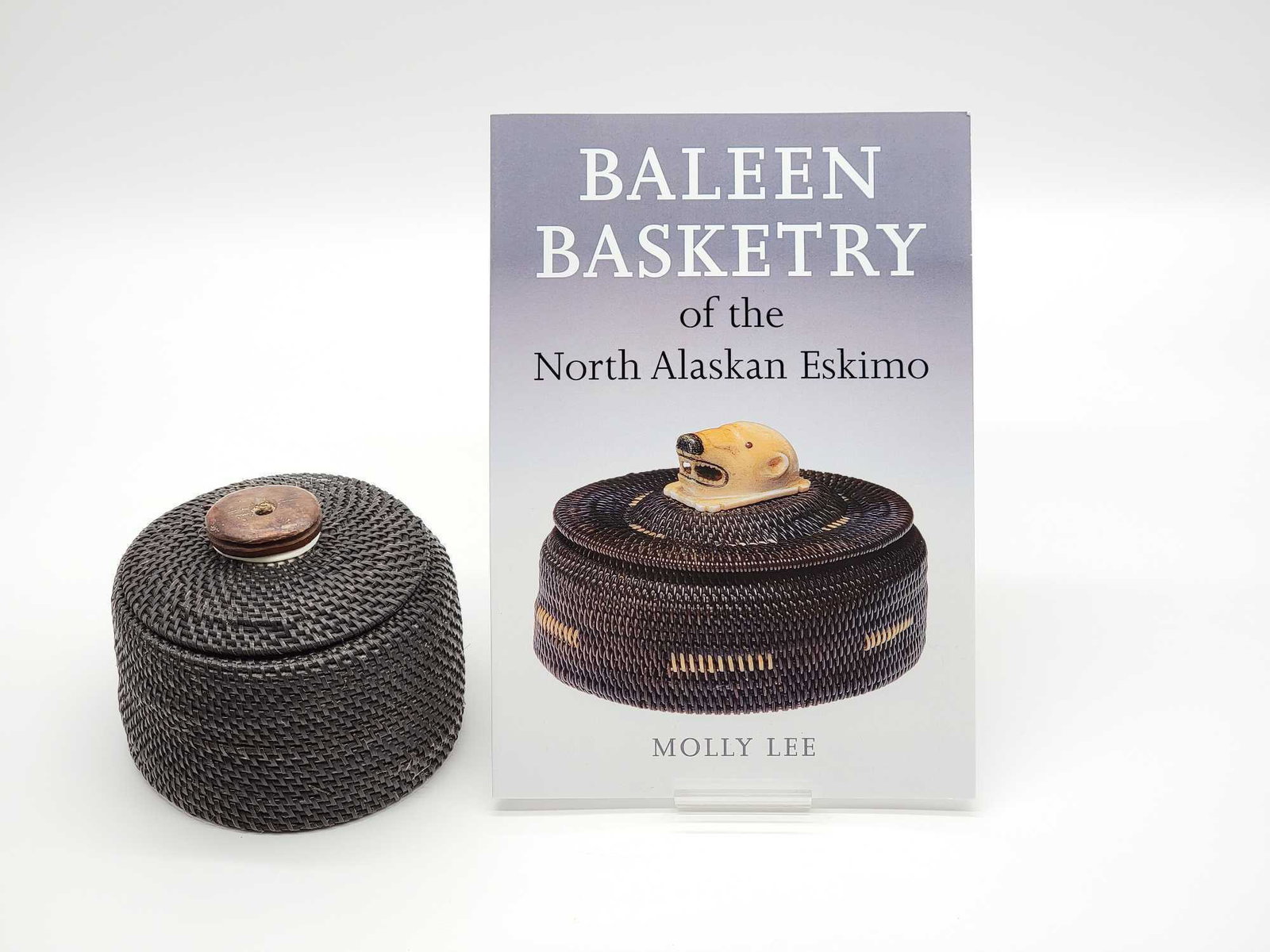 Iñupiaq Baleen Basket by Marilyn Hank Otton: A fine Iñupiaq baleen basket by the prominent Point Hope, AK basket maker, Marilyn Hank Otton, accompanied by a copy of the book Baleen Basketry of the North Alaskan Eskimo by Molly Lee, for whic