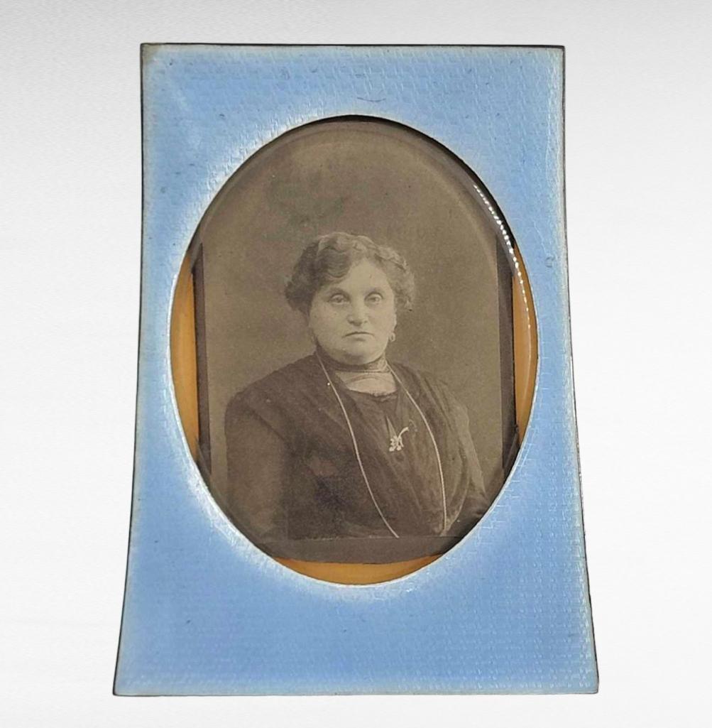 Silver Guilloché Enamed 88 Zolotnik Photo Frame: A very fine antique 88 zolotnik silver blue guilloché enameled photo frame with integrated silver easel back and oval reveal featuring a period black and white photograph of a mature woman. The f