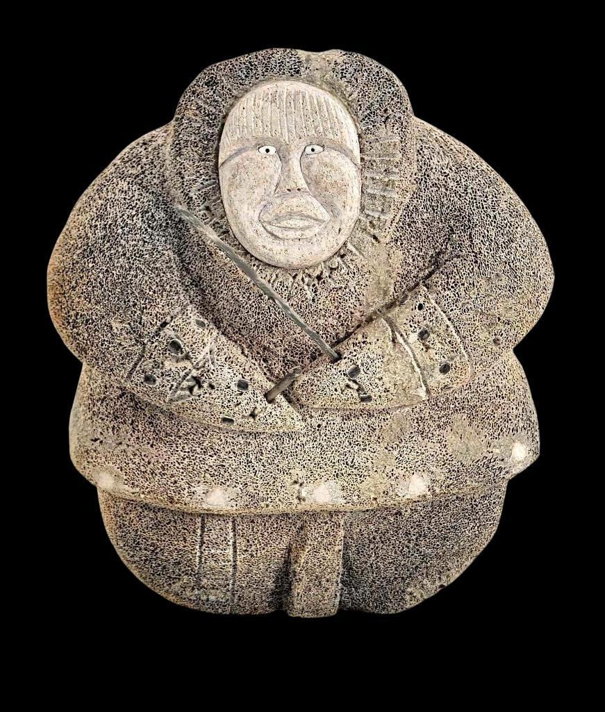Large Eskimo Drummer Carved Whalebone Figure: A sizable Iñupiaq mineralized whalebone carving with contrasting accents and face, the face inlaid with walrus tusk and baleen eyes, the figure holding sticks, likely at one point one of which wo