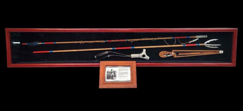 Aleut Throwing Spear & Atlatl Display - Peter Lind, Sr.: A fine and large Aleut hunting implement display by the prominent Alaskan artist of Alutiiq and Swedish descent Peter Lind Sr. (b.1930). The set, constructed from wood, walrus tusk, baleen, synthetic