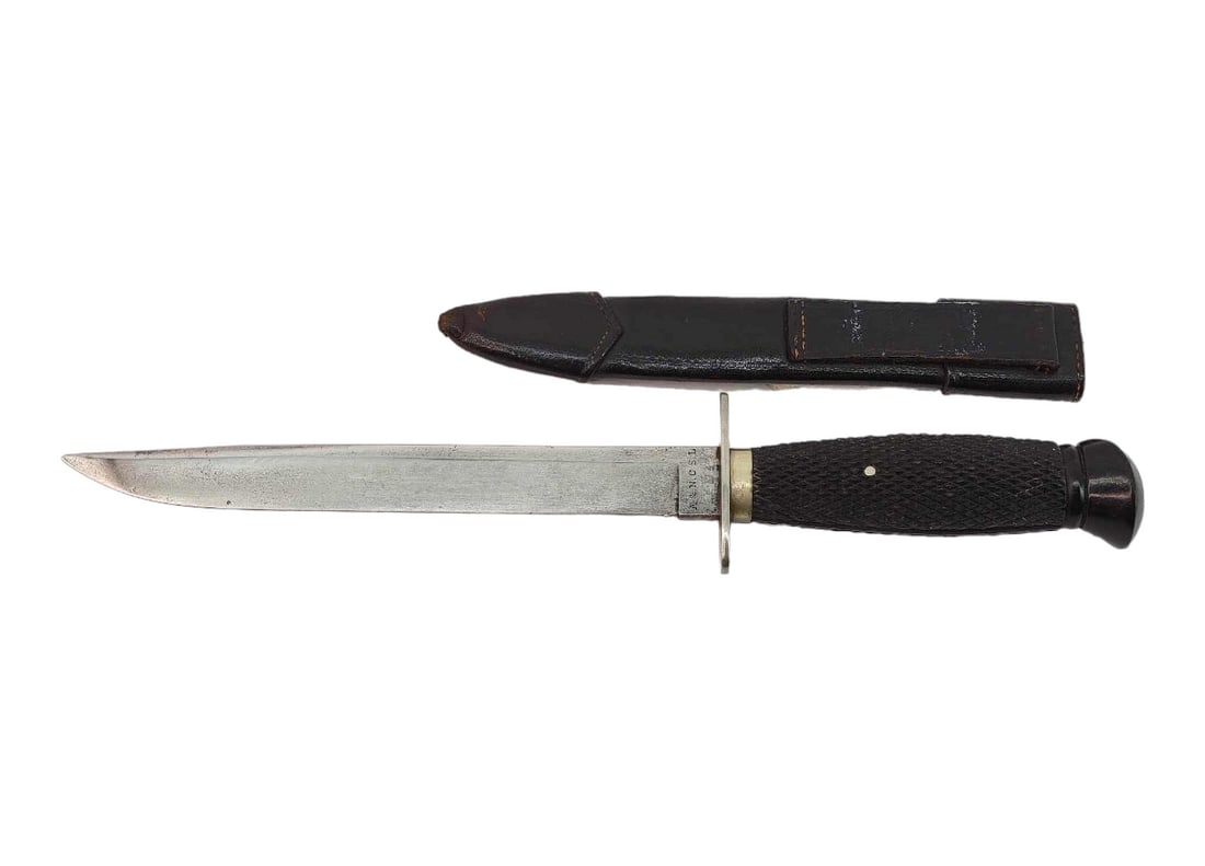 Army Navy British Sheffield Belt Knife w/Sheath: A fixed antique straight back blade with a hidden tang. Blade is marked A& N.C.S L and N on the ricasso and meets the faceted composite handle at the guard, handle has one pin and ends in a pommel
