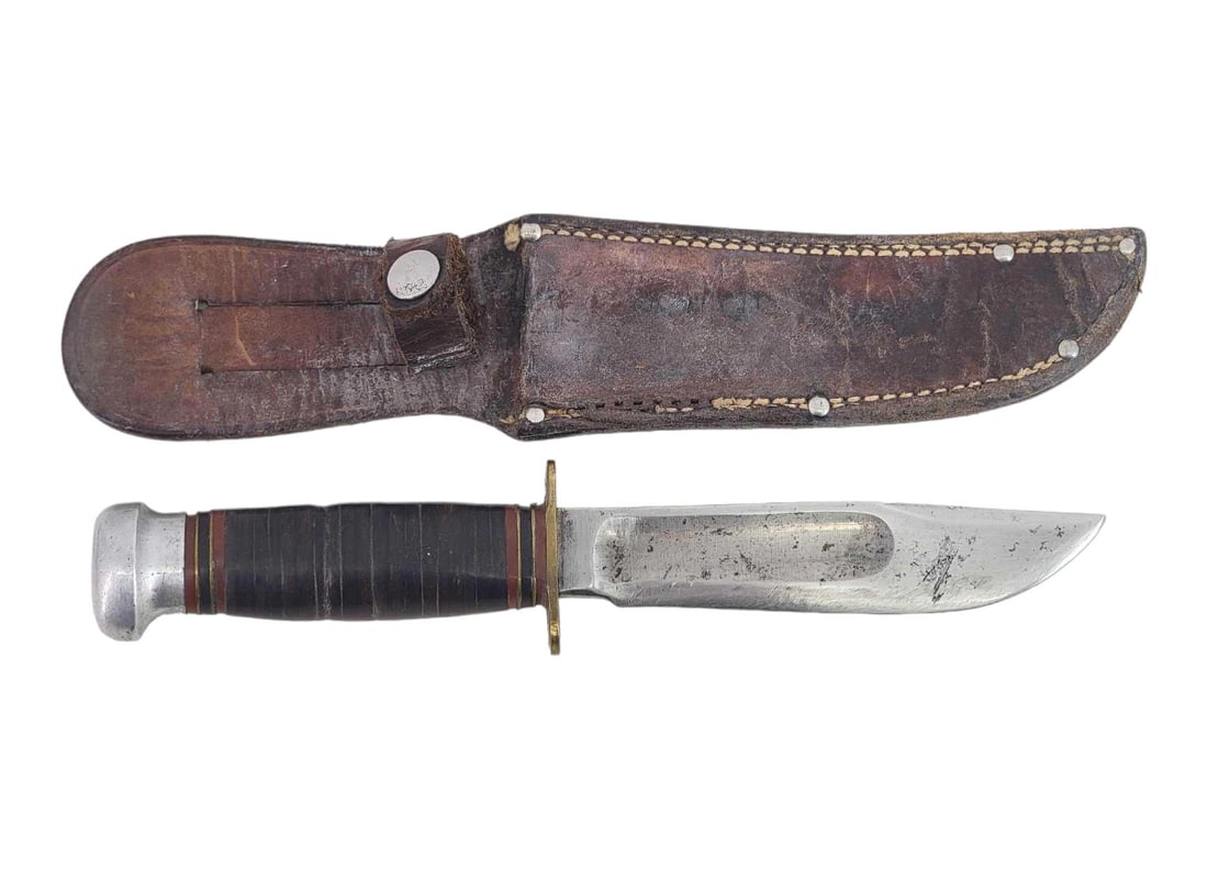 Marble's Ideal 5" Hunting Knife w/Sheath: A Marbles Ideal hunting knife with large blood groove, brass hilt, and aluminum pommel exposing a full-length rattail tang. Grip is of stacked leather and bound by spacers at either end. Housed in a l