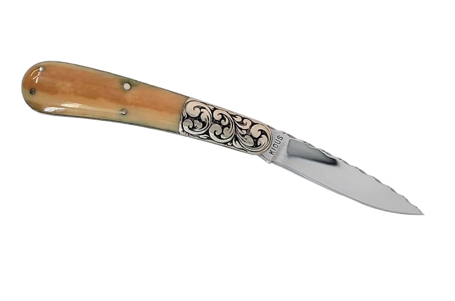 Ornate Joe Kious Folding Pocket Knife: A beautiful early swayback drop-point single blade folding pocket knife, crafted by the late Joe Pious of the Knifemakers’ Guild, featuring a polished fossilized walrus tusk handle. Handle has four 