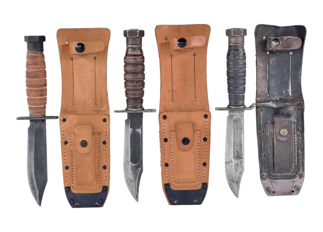 Camillus Vietnam Era Jet Pilot Bowie Knives & Ontario Desert Storm Bowie w/ Sheaths: Selection of two Vietnam era U.S. Jet Pilot fixed Bowie knives by Camillus, NY, and a Desert Storm (1990-1991) Ontario Bowie all with jimping, full guard, prominent blood grooves, full stick tang cons