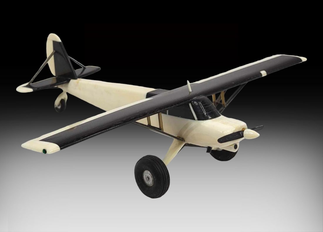 Walrus Tusk & Baleen Super Cub No. 1 Airplane - Al Kaloke: A beautiful Super Cub Number 1 aircraft model carved from walrus tusk and baleen, with spinning baleen propeller on the front. Signed on the underside of the plane body by the late Iñupiaq artist Alf