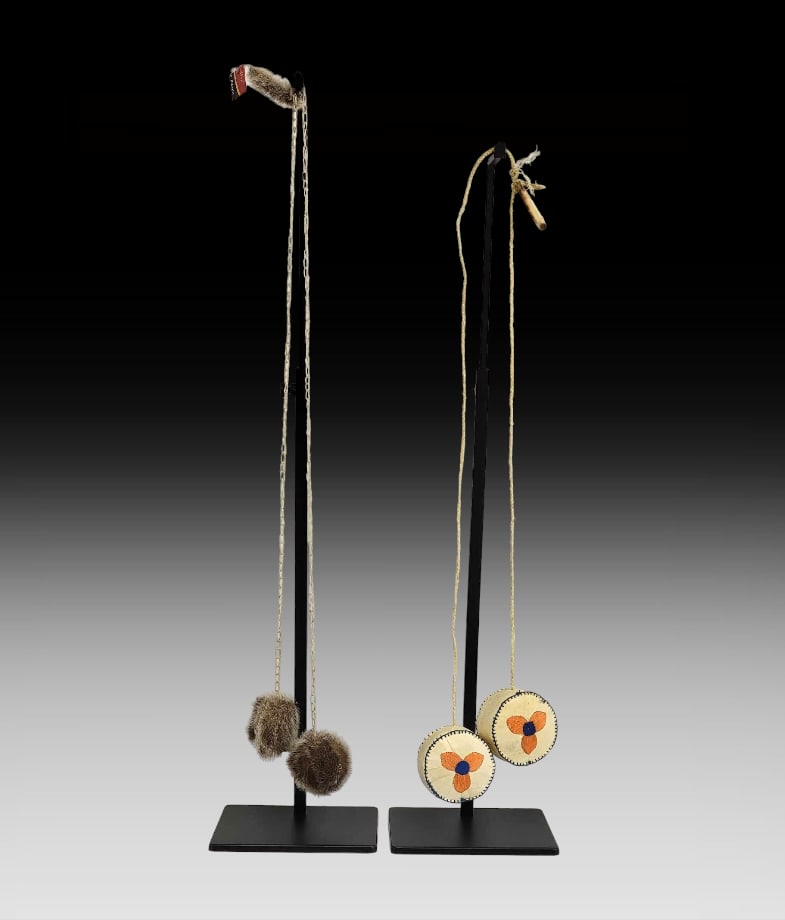 Yup'ik Yo-Yos: Two Yup'ik style yo-yos includes one set comprised of two thick caribou skin medallions, each hand-stitched with blue embroidery floss and embellished with orange and blue flowers; balls are attac