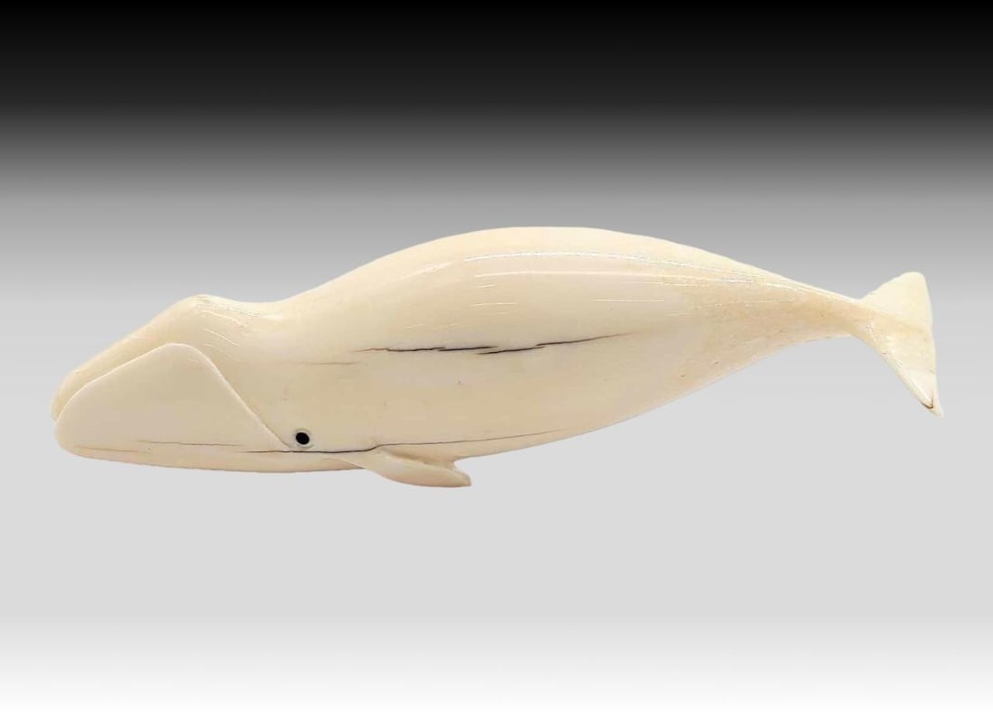 Walrus Tusk & Baleen Bowhead Whale - Michael Slwooko: A walrus tusk carved bowhead whale with inset baleen eyes. Signed on the underside by Yup'ik artist Michael Slwooko of St. Lawrence Island, Alaska. Measures approximately 6.75" x 1.5" x 2&
