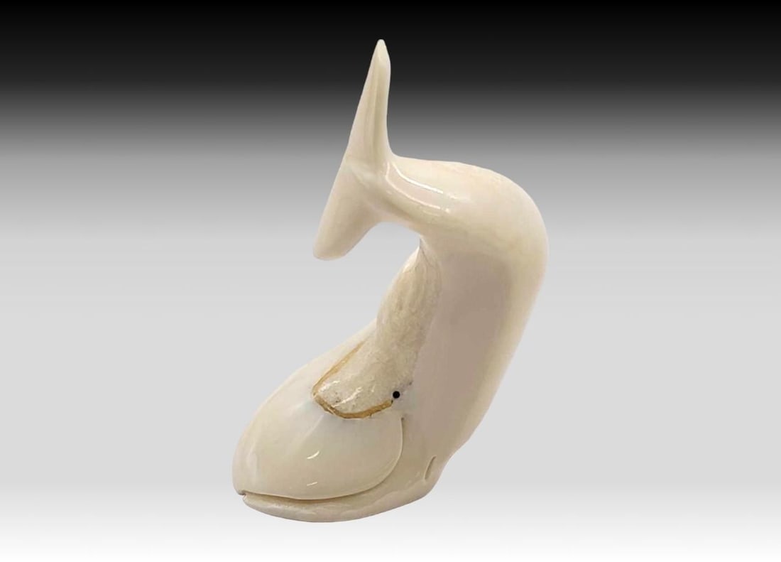 Walrus Tusk Bowhead Whale - Darin Slwooko: A walrus tusk carved bowhead whale in breaching position. Signed on the underside by Yup'ik artist Darin Slwooko of Gambell, St. Lawrence Island, Alaska. Measures approximately 2" x 1.25" 