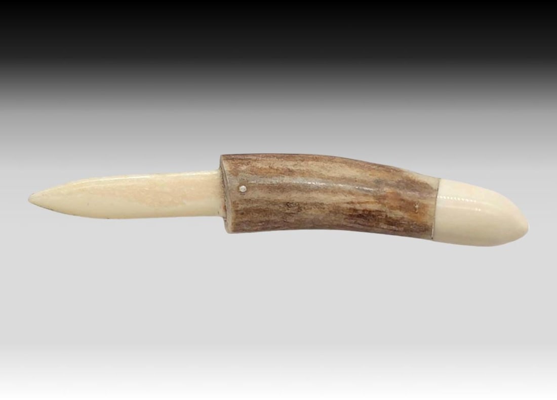 Walrus Tusk Letter Opener w/ Antler Handle: A letter opener crafted from a walrus tusk blade and antler handle, the handle terminating in a walrus tusk cap. Measures approximately 1" x 5.75" long.