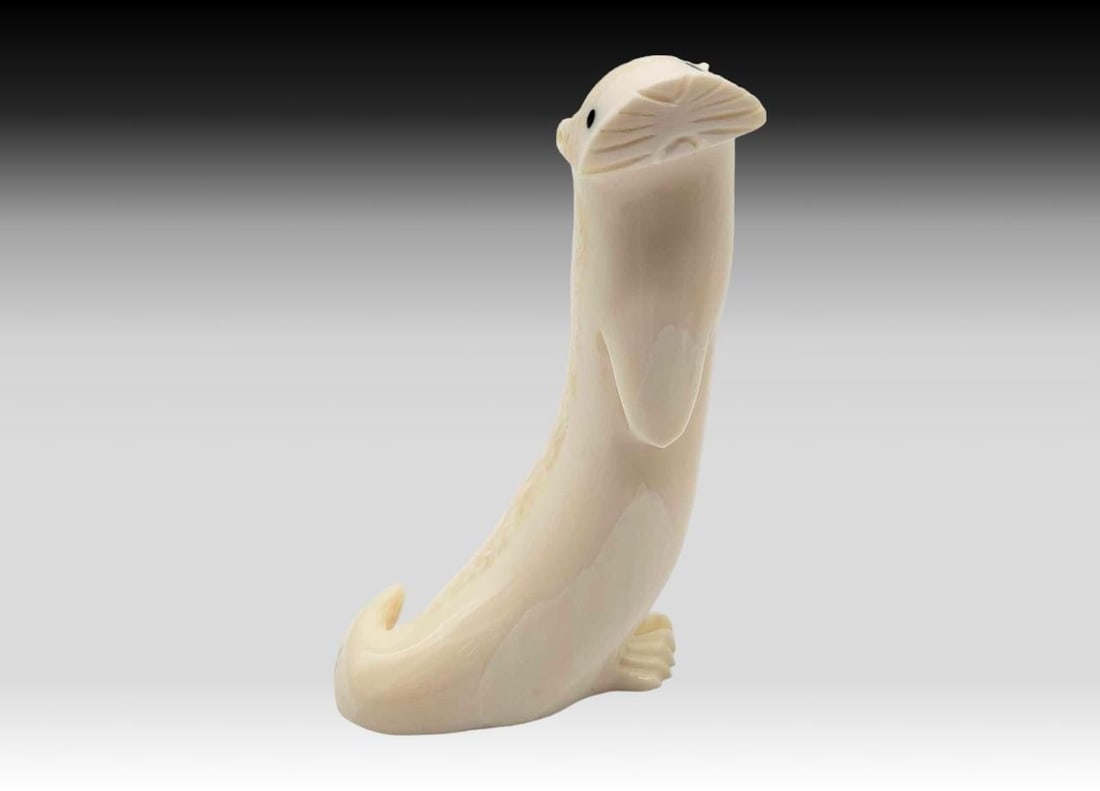 Walrus Tusk & Baleen River Otter: A carved walrus tusk river otter, standing erect, and accented with baleen eyes. Initialed on the underside for P.F.A. and measures approximately 2.75" x 1" x 3.5" tall.