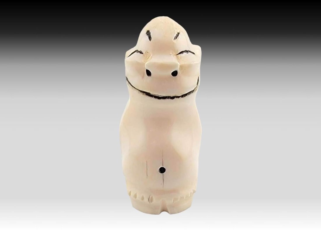 Walrus Tusk Scrimshaw Billiken Figurine - Dwight Milligrock: A walrus tusk carved billiken figurine with scrimshaw details, initialed on the underside for D.M for Dwight Milligrock, Sr. (1911-1994) from Diomede, Alaska. . Measures approximately 1" x 1" 